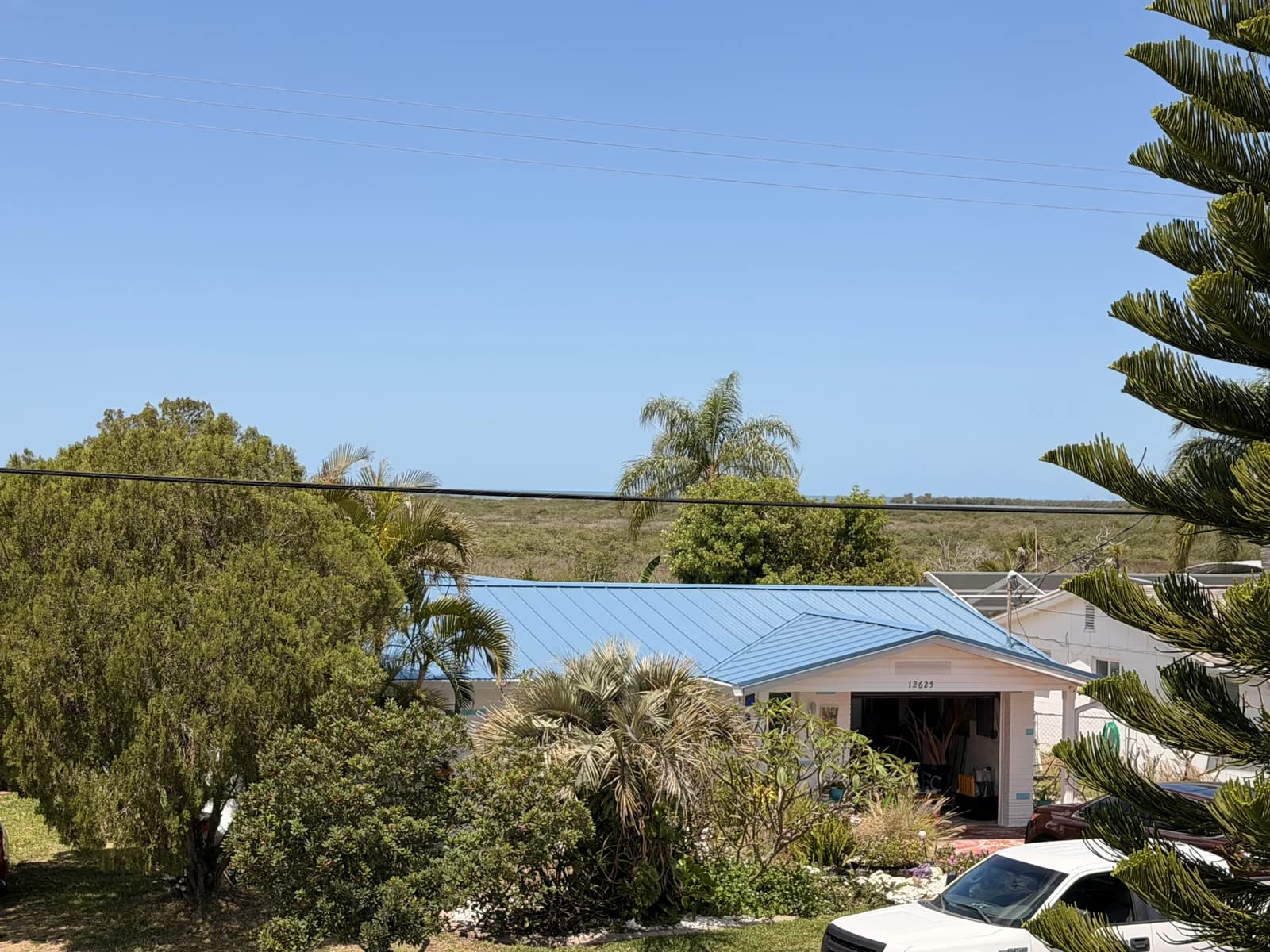 Standing-seam blue metal roof installed by Protech Roofing on a coastal Florida home near the Gulf