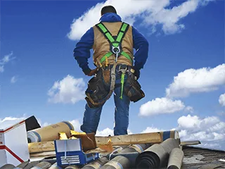 Professional roof inspection in Brooksville, FL by a Protech Roofing specialist in a safety harness.