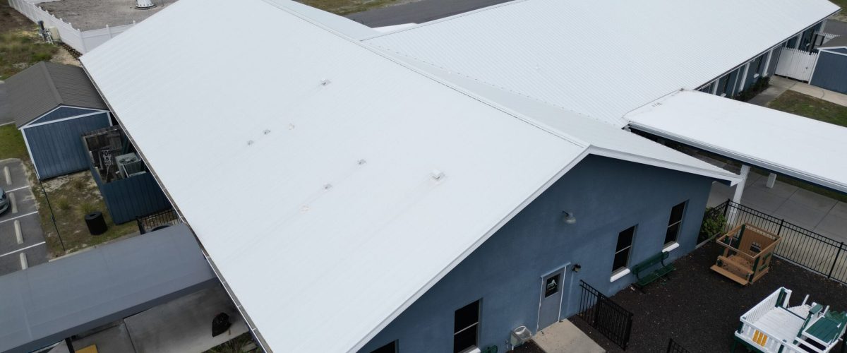 Commercial silicone roof coating installation in Brooksville, FL by Protech Roofing.
